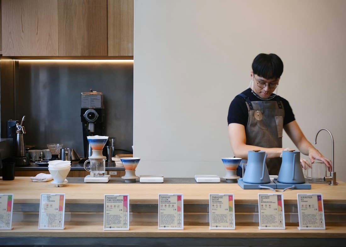 Barista preparing coffee behind a counter