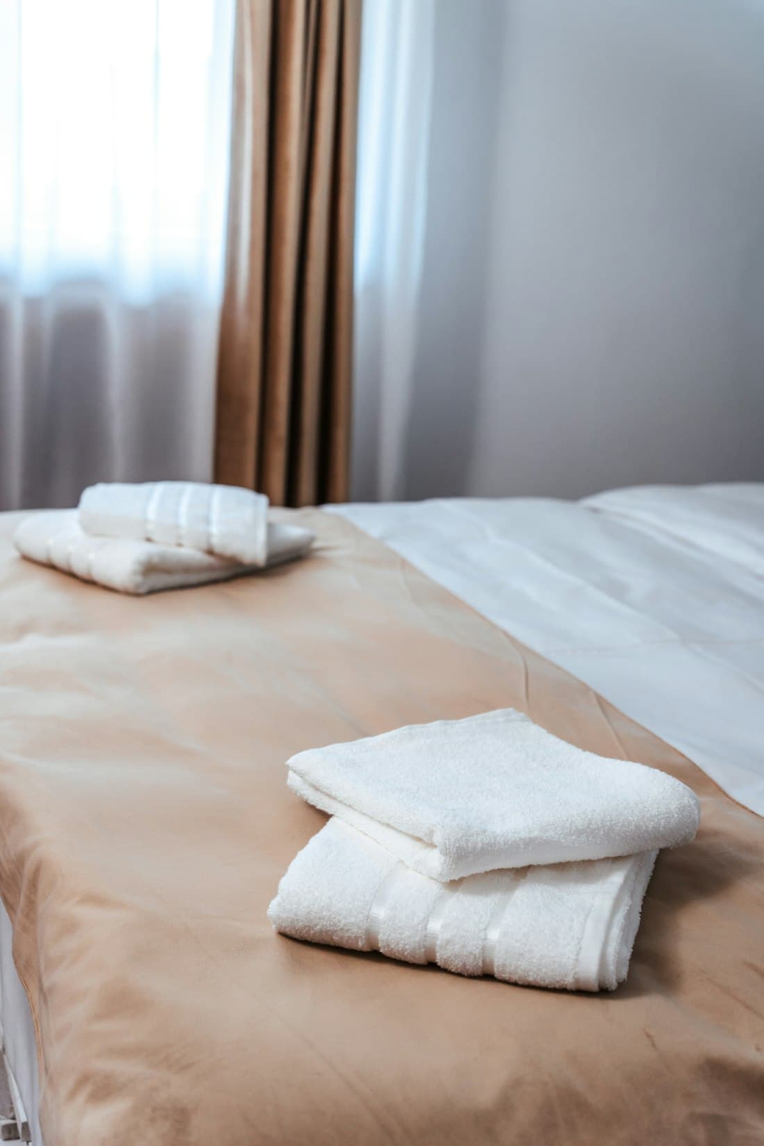 Fresh linen and towels prepared in a hotel room